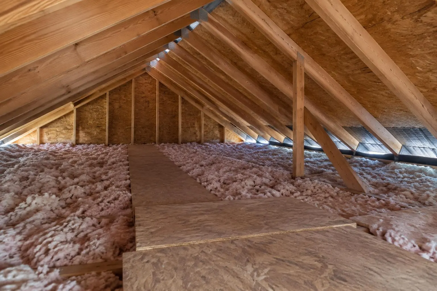 Illustrative attic view showing insulation kept back from the eaves and daylight at the soffit intake