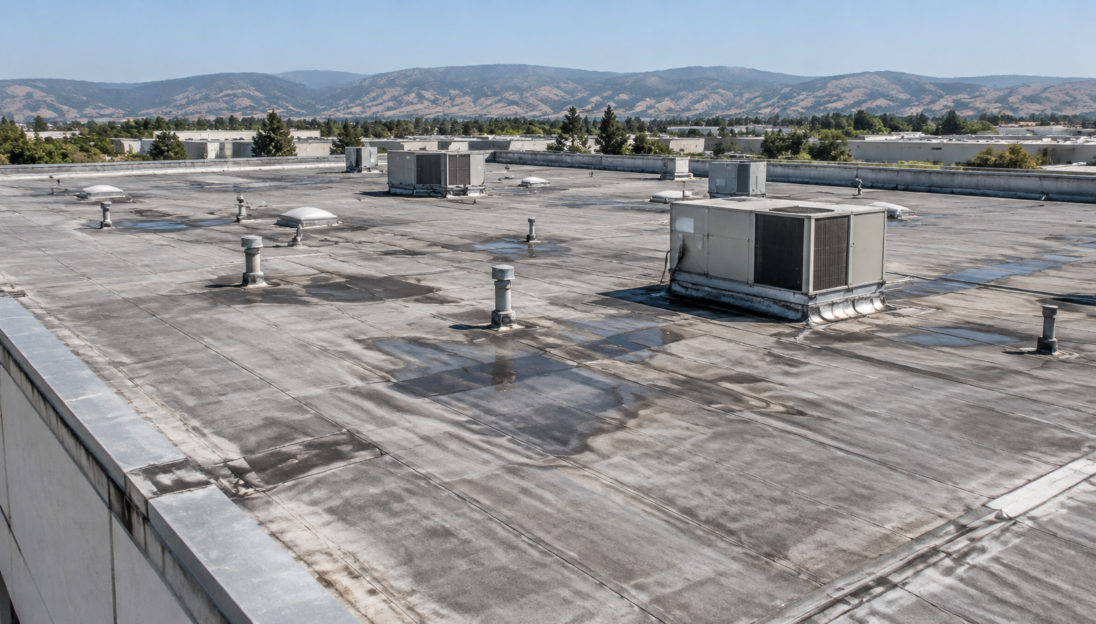 Illustrative view of an aged low slope commercial roof before replacement